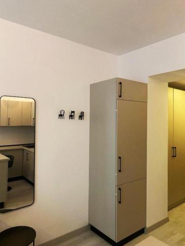 a room with a mirror and a refrigerator at YamaLuxe Luxury Apartments - București in Bucharest