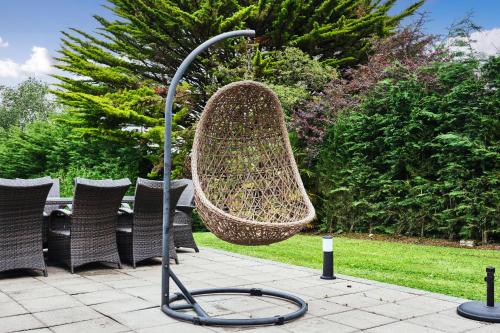a metal object with a basket on a patio at Loughside Lodge - Fermanagh 5 bed waterside bungalow in Culky