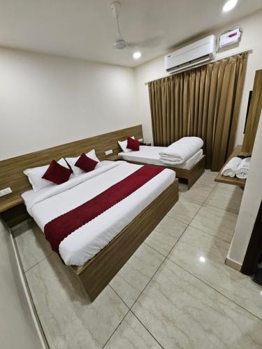 a hotel room with two beds in a bedroom at Hotel JR INN in Ludhiana