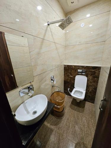a bathroom with a sink and a toilet at Hotel JR INN in Ludhiana