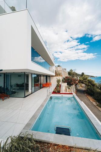 a swimming pool in the backyard of a house at Villa Deluxe Zaostrog in Zaostrog