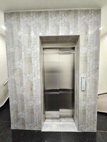a elevator in a building with a wall at Hotel JR INN in Ludhiana