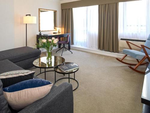 a living room with a couch and a table at Cheval Knightsbridge in London