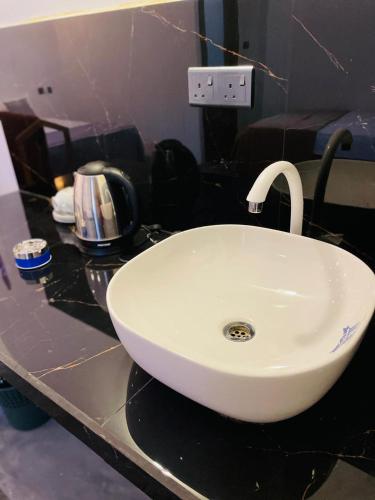 a white sink on a counter in a bathroom at Sea Wawes Hiriketiya in Hiriketiya