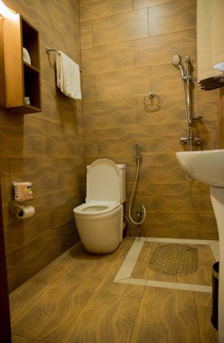 a bathroom with a toilet and a sink at Velvet Suites in Kigali
