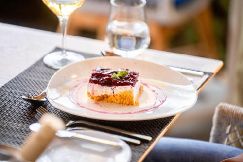 a piece of cake on a plate on a table at Sentido Kyknos Beach Adults Only in Malia