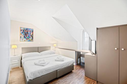 Aparthotel Hine Adon Fribourgにあるベッド