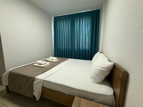 a bedroom with a bed with two towels on it at Hotel Majestic in Struga