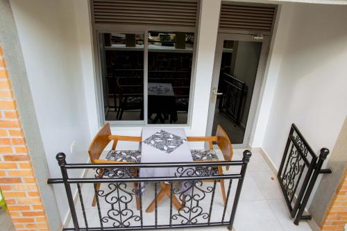 a balcony with a table and chairs on it at Velvet Suites in Kigali