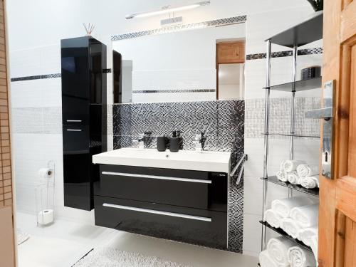 a bathroom with a sink and a mirror at Castle View Retreat Breakfast available in Trenčín
