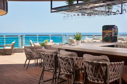 a bar on a cruise ship with the ocean in the background at Hotel Grand Kaptan - Ultra All Inclusive in Alanya