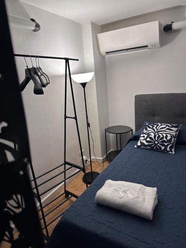 a bedroom with a blue bed and a lamp at Dolce vita Florence room in Florence