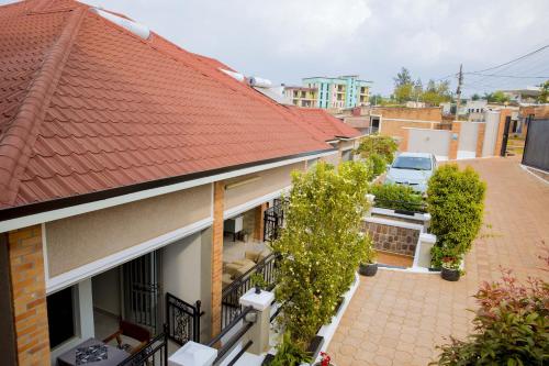 a house with an orange roof and a balcony at Velvet Suites in Kigali