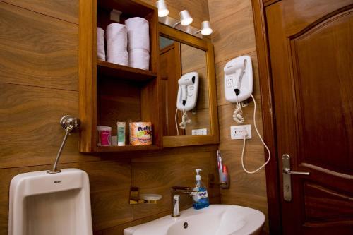 a bathroom with a sink and a mirror at Velvet Suites in Kigali
