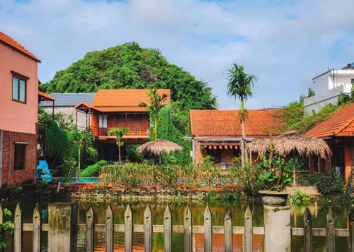 a house with a fence in front of a house at Trang An Village Homestay in Ninh Binh