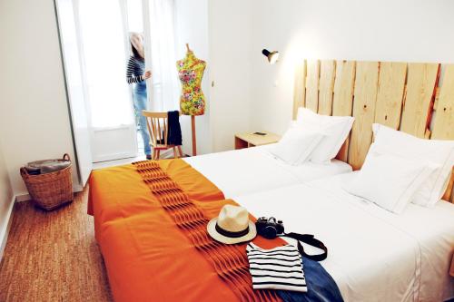 a hotel room with a bed with a hat on it at Hall Chiado in Lisbon
