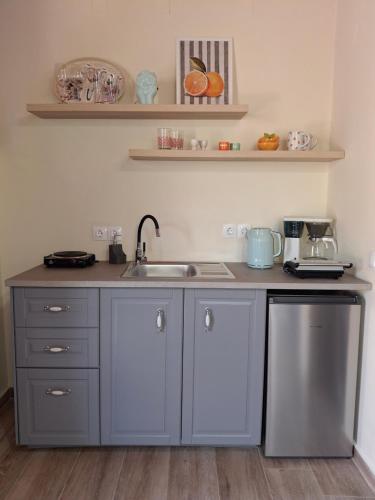 a kitchen with a sink and a counter at Terra Solaris Guesthouse in Kissamos