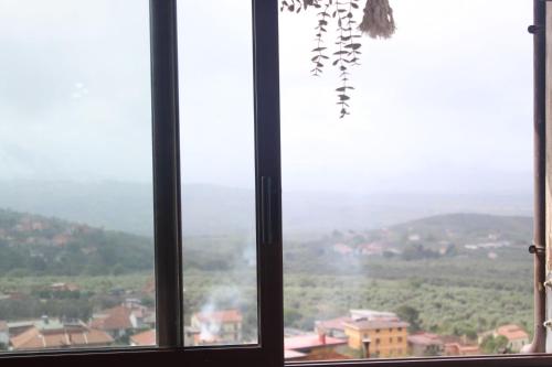 a window with a view of a city at La Terrazza in Campagna