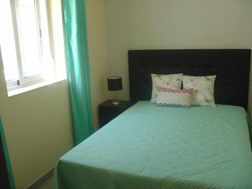 A bed or beds in a room at Casa Verão Azul