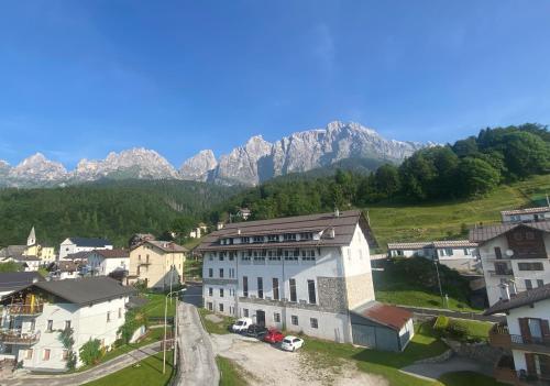 an aerial view of a village with mountains in the background at Mansarda Chiara - locazione turistica in Gosaldo