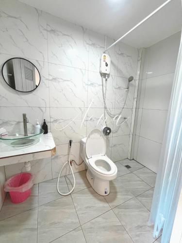 a bathroom with a toilet and a sink and a shower at Aona Resort Kohlarn in Ko Larn