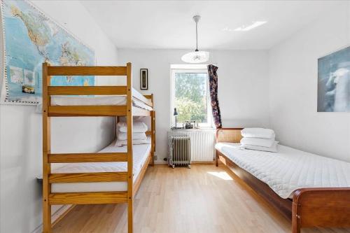 a bedroom with two bunk beds and a ladder at 3073-Stege-Bundgarnet-23 in Stege