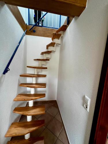 a staircase in a house with wooden steps at Vogtadeshof in Wolfach