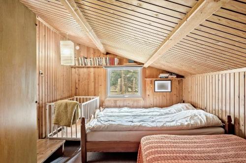 a bedroom with two beds in a wooden house at 2030-Stege-Ulvshalevej-305 in Stege