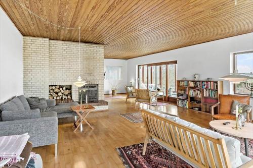 a living room with a couch and a fireplace at 4062-Borre-Klintevej-462 in Borre