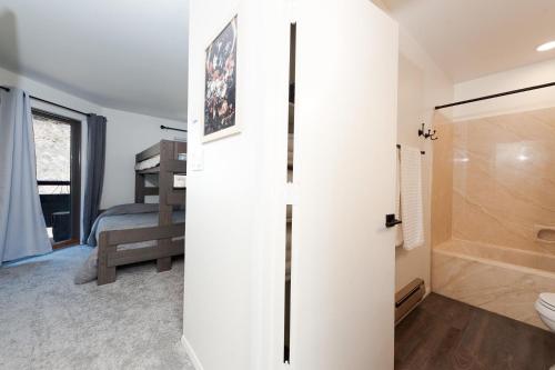 a bathroom with a shower and a toilet and a sink at Pine Acres - Unit 102 in Hermosa