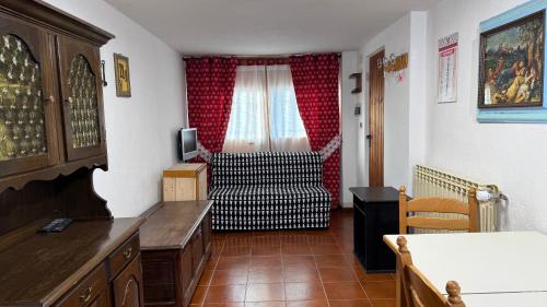 a living room with a chair and a window at Hostdomus - La Casa di Merlino in Oulx