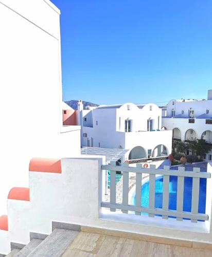 a view from the balcony of a house with a swimming pool at New Haroula in Fira