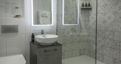 a bathroom with a sink and a shower at Best Western Hotel de Havelet in St Peter Port
