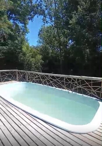 a swimming pool on top of a wooden roof at Cabañas El Tercer Ojo Tigre in Tigre