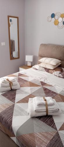 two beds in a room with towels on them at Casa vacanza Luna in Eboli