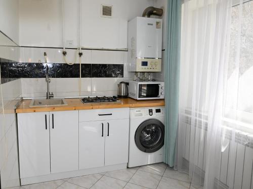 a white kitchen with a washing machine and a sink at Your lovely stay in Yerevan, Komitas 30 in Yerevan