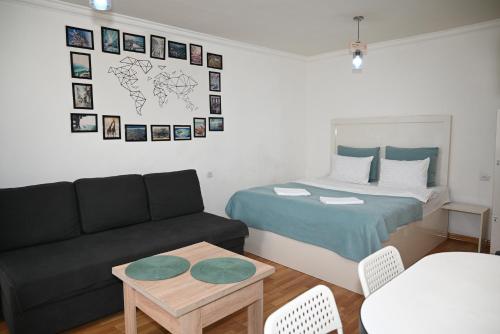 a living room with a bed and a couch at Your lovely stay in Yerevan, Komitas 30 in Yerevan