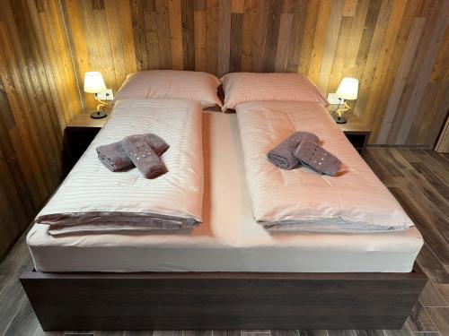 two twin beds with towels on top of them at Sklep "OSUD" in Mutěnice