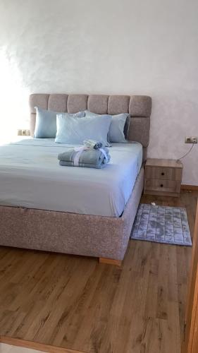 a large bed in a bedroom with a wooden floor at Two bedroom Apartment in Bouznika Beach in Bouznika
