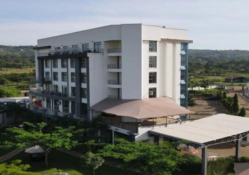 a large white building with a canopy in front of it at Fairways Hotel Kisumu in Kisumu