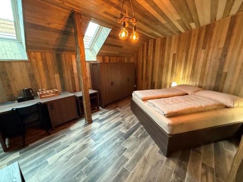 a bedroom with a bed in a wooden room at Sklep "OSUD" in Mutěnice