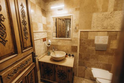 a bathroom with a sink and a toilet and a mirror at Timur inn Cappadocia in Goreme