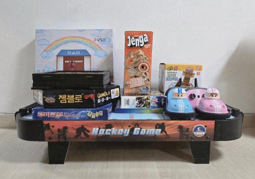 a toy table with a stack of toys and a rainbow at Guesthouse Jaysory 수원 행궁 in Suwon