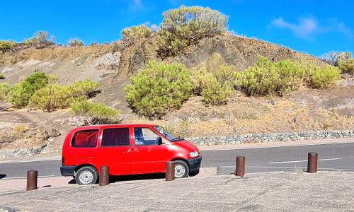 a red van parked on the side of a road at w DiscoveryCanarias II in San Miguel de Abona