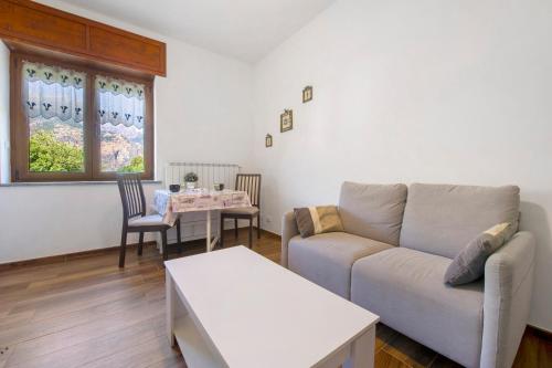 a living room with a couch and a table at Welcome Home 2 Meana di Susa in Meana di Susa