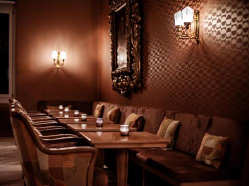 a dining room with a long table and chairs at Hotel Prätschli in Arosa
