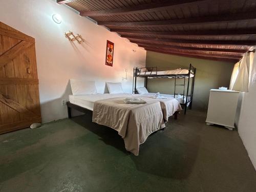 a bedroom with a bed and a wooden ceiling at Pousada Mojomar Buzios in Búzios