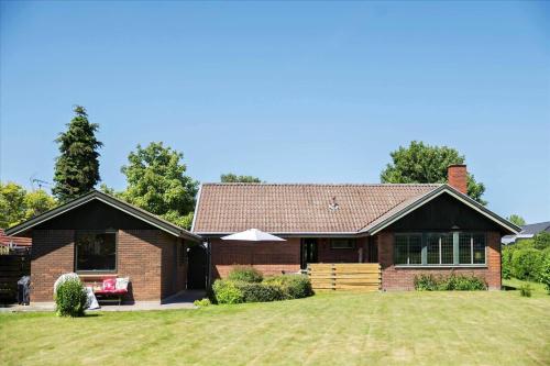 a brown brick house with a grass yard at R614-Rodvig-Stevns-Strandvaenget-1 in Rødvig