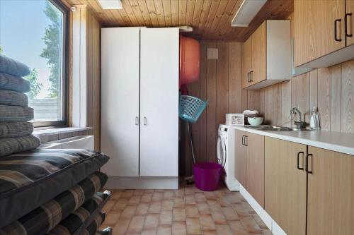 a kitchen with a couch in a tiny house at R614-Rodvig-Stevns-Strandvaenget-1 in Rødvig