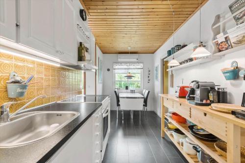 a kitchen with a sink and a counter top at R973-Rodvig-Stuven-61 in Rødvig